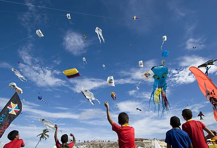 Children fly kites during an international kite festival in Cartagena